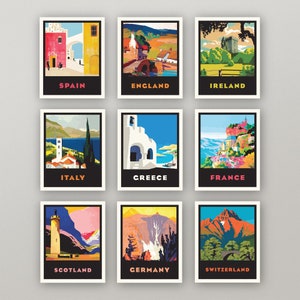 May include: Nine vintage travel posters featuring iconic landmarks and landscapes from different countries. Each poster has a black border and a white background with the country name printed in bold at the bottom. The posters depict scenes from Spain, England, Ireland, Italy, Greece, France, Scotland, Germany, and Switzerland.