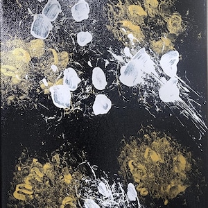 May include: Abstract painting on a black canvas. The artwork features white and gold paint splatters and blotches. The white paint is applied in a splattered effect, while the gold paint appears in clusters. The canvas is square.