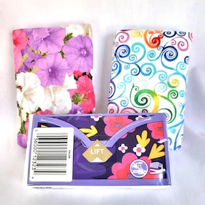 May include: An assortment of floral-patterned items. Two folded fabric items feature petunia and swirl designs. A purple box with a floral design and the word "LIFT" is in the center. A barcode is on the left side.