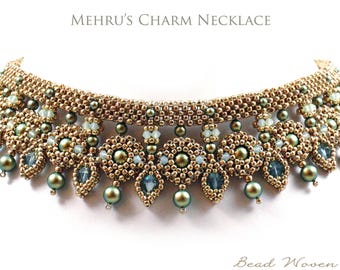 May include: A beaded necklace with the text "Mehru's Charm Necklace". The necklace features a gold-colored base with olive green and blue accents. The design includes dangling teardrop-shaped beads and round beads.