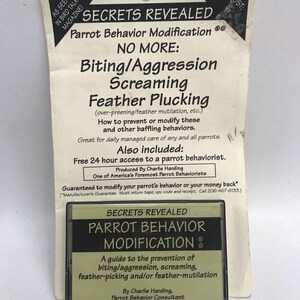 May include: A vintage cassette tape titled "Secrets Revealed Parrot Behavior Modification" with a guide to prevent biting, aggression, screaming, and feather plucking. The packaging includes text about parrot behavior and a guarantee.