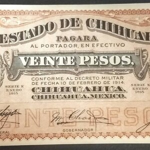 May include: A vintage banknote from the State of Chihuahua, Mexico, featuring a portrait of a man in a suit and tie, with the text "El Estado de Chihuahua" and "Veinte Pesos" printed in bold. The note is dated 1915 and has a serial number of 4169180.