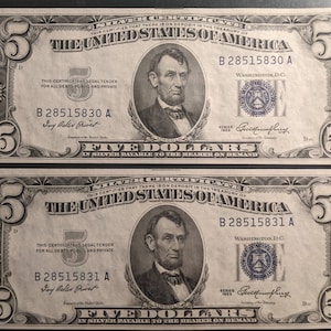May include: Two vintage five dollar bills featuring a portrait of Abraham Lincoln. The bills are from 1953 and have the serial numbers B 28515830 A and B 28515831 A.
