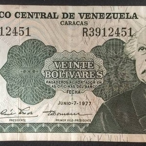 May include: A twenty bolivares banknote from Venezuela featuring a portrait of Jose Antonio Paez, a Venezuelan military leader and politician. The banknote is green and white with the text "Banco Central de Venezuela" and "Veinte Bolivares" printed on it.
