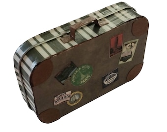 May include: A rectangular metal suitcase featuring a green and white striped pattern on the top and sides. The brown front panel is decorated with various vintage-style travel stickers, including labels for Hotel Atlanta and Paris.