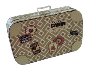 May include: A rectangular metal suitcase featuring a beige and white geometric lattice pattern. The exterior is decorated with various vintage-style travel stickers, including labels for Hotel Excelsior Siena, National Hotel Cairo, and a P. & O. S. N. Co. Cabin tag.