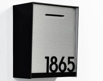 May include: A black metal mailbox with a silver front panel and a black number "1865" on the front.