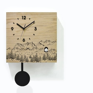 May include: A wooden cuckoo clock with a mountain and forest scene. The clock has a black pendulum and a white cuckoo bird that pops out of the clock face.