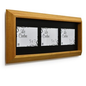 May include: A wooden triple picture frame with a black interior. Each opening is designed for 12.7 x 17.8 cm photos. The frame has a natural wood finish and features the text "Le Cadre" on the included inserts.