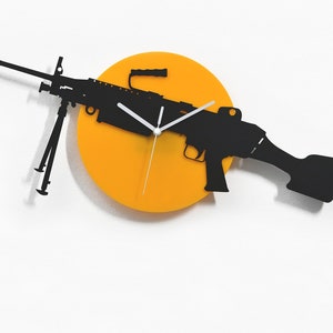 May include: A black silhouette of a machine gun with a white clock face on a bright orange circular background. The clock hands are white. The text "Sol Pixie Dust" is at the bottom of the image.