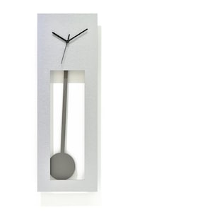 May include: A silver-coloured wall clock with a pendulum. The clock face is white with black hands. The clock is rectangular and has a modern design.