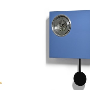 May include: A blue square clock with a silver face and a pendulum. The clock has a visible gear mechanism and Roman numeral markings.