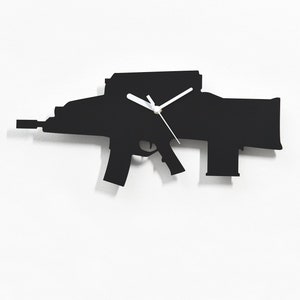 Puede incluir: Silueta negra de un reloj con forma de rifle en una pared blanca. Las manecillas del reloj son blancas.