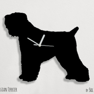 May include: Black silhouette of a Black Russian Terrier dog with clock hands in the center. The text "BLACK RUSSIAN TERRIER" is below the image and "BY SOL PIXIE DUST" is below the text.