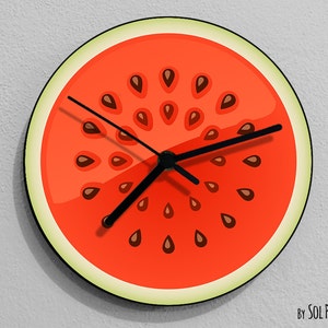 May include: A red watermelon clock with black hands and brown seeds. The clock is round and has a white rim.