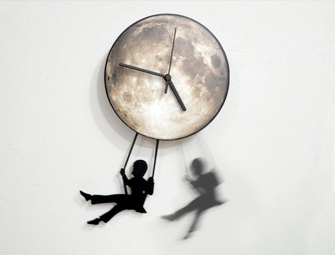 Boy Swinging on the Moon Wall Clock With Pendulum Wall pic