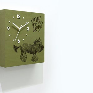 Puede incluir: Un reloj cuadrado de madera verde con una esfera blanca y agujas negras. El reloj tiene una ilustración en blanco y negro de un perro con el texto "my love" encima.
