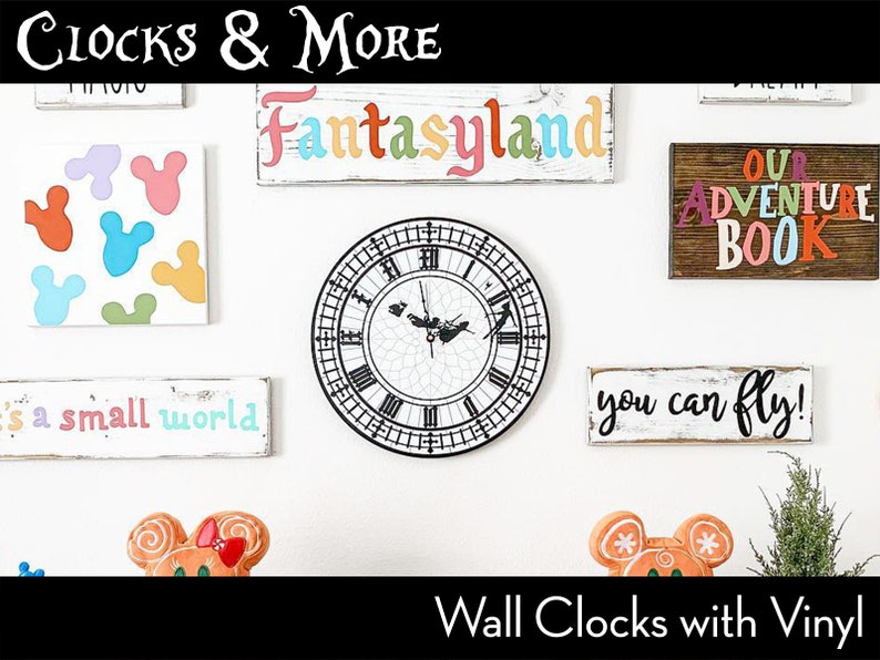 May include: A white wall with various wall decor, including a clock with black Roman numerals, a sign that says "Fantasyland", and a sign that says "Our Adventure Book". The wall decor is themed around Disney.