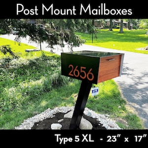 May include: A modern post mount mailbox with the number 2656 in orange. The mailbox is black and wood-toned, with a black post. The dimensions are 23 inches by 17 inches.