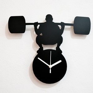 Silueta de levantamiento de pesas Mr Universe - Reloj de pared