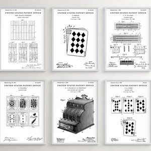 May include: Six black and white vintage patent drawings for playing cards and a cash register. The drawings are framed and displayed on a white wall.