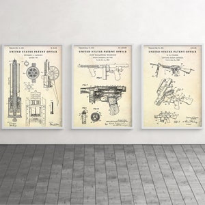 May include: Three vintage United States Patent Office drawings of firearms. The first drawing is for a Gatling gun, the second is for a Thompson submachine gun, and the third is for a Stoner 63 light machine gun.