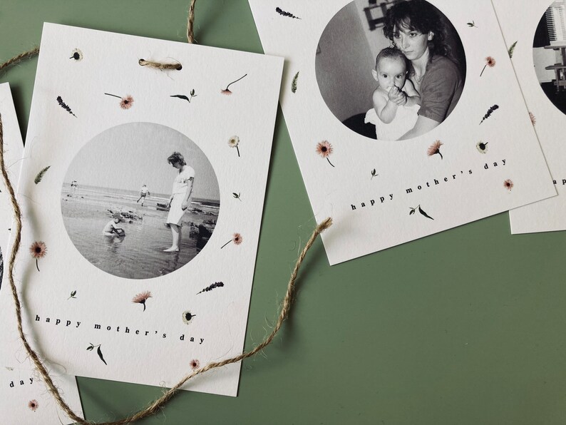 May include: White Mother's Day cards with black and white photos inside a circle, surrounded by small floral and leaf illustrations. The words "happy mother's day" are printed at the bottom of each card. A natural twine string is attached to the cards.