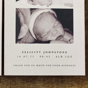 May include: A black and white photograph of a newborn baby girl named Felicity Johnstone, born on 14 July 2022 at 08:45, weighing 6 pounds and 2 ounces.