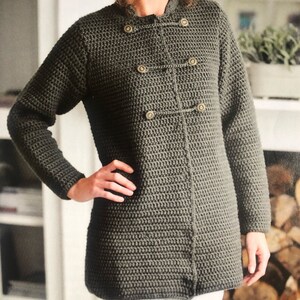 May include: A long-sleeved, dark green crocheted cardigan with a double-breasted button closure. The cardigan has a stand-up collar and is made with a textured stitch.