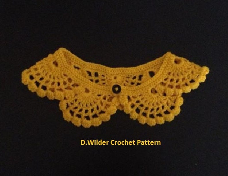 May include: A yellow crocheted collar with a black button in the center. D. Wilder Crochet Pattern is written below the collar.