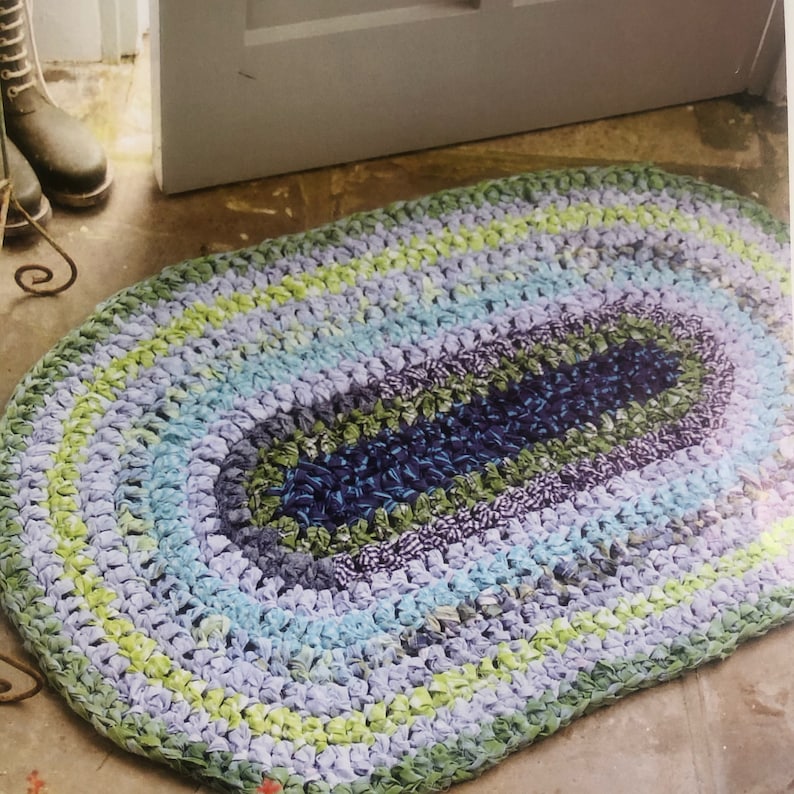 Crochet Eco Friendly Rag Oval Rug Pattern Transforming recycled cotton fabric into rugs. Ideal for eco-conscious homes, this durable rug adds rustic charm to any room. It's the perfect blend of style and sustainability.
