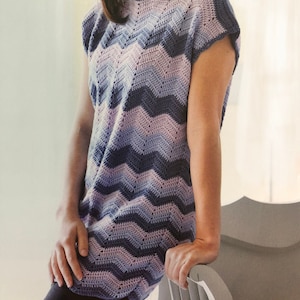 May include: A crocheted top with a chevron pattern in shades of blue and purple.