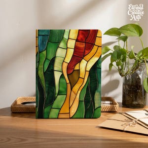 May include: A rectangular notebook featuring a stained glass pattern on the cover with vertical segments in shades of deep green, light green, yellow, orange, and dark red, separated by thin black lines, creating a vibrant mosaic effect.