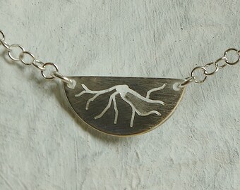Sterling silver necklace with sawed tree roots.