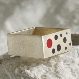 Sterling square ring with black points and a red one. Modern unisex ring.