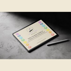May include: A digital tablet displaying "THE SACRED ENERGY" journal with chakra symbols. The journal is designed to track emotional patterns and energy alignment. A white stylus rests beside the tablet on a gray surface.