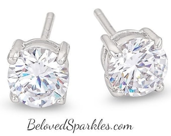 May include: A pair of silver stud earrings with a clear round cubic zirconia stone in each earring.