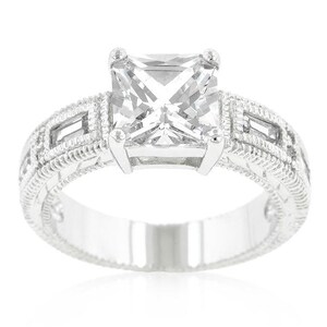 May include: A silver ring with a large, square-cut, clear gemstone. The band is decorated with a delicate, intricate design.