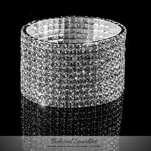 May include: A silver rhinestone bracelet with multiple rows of sparkling stones.