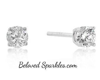 May include: A pair of diamond stud earrings. Each earring has a round, brilliant-cut diamond in a four-prong setting. The earrings are shown on a white background, with the text "Beloved Sparkles.com" at the bottom.