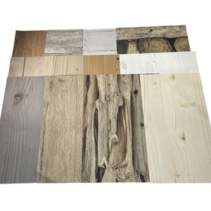 May include: A collection of wood-look samples, showcasing various textures and colors. The samples include light and dark wood grains, weathered planks, and a section of stacked logs. The color palette ranges from light beige to dark brown.