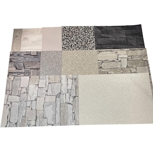 May include: A selection of nine textured samples, displaying diverse surface designs. The samples feature wood grain, speckled, and stone-like patterns in shades of grey, beige, and black. The arrangement is a grid, offering a variety of textures for interior design.