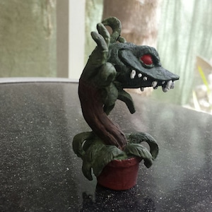 Man eating plant statue
