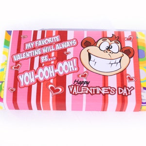May include: A pink and red striped Valentine's Day card with a cartoon monkey face and the text "My favorite Valentine will always be... You-ooh-ooh! Happy Valentine's Day".