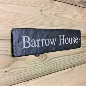 May include: A black slate house sign with the text "Barrow House" engraved in white.