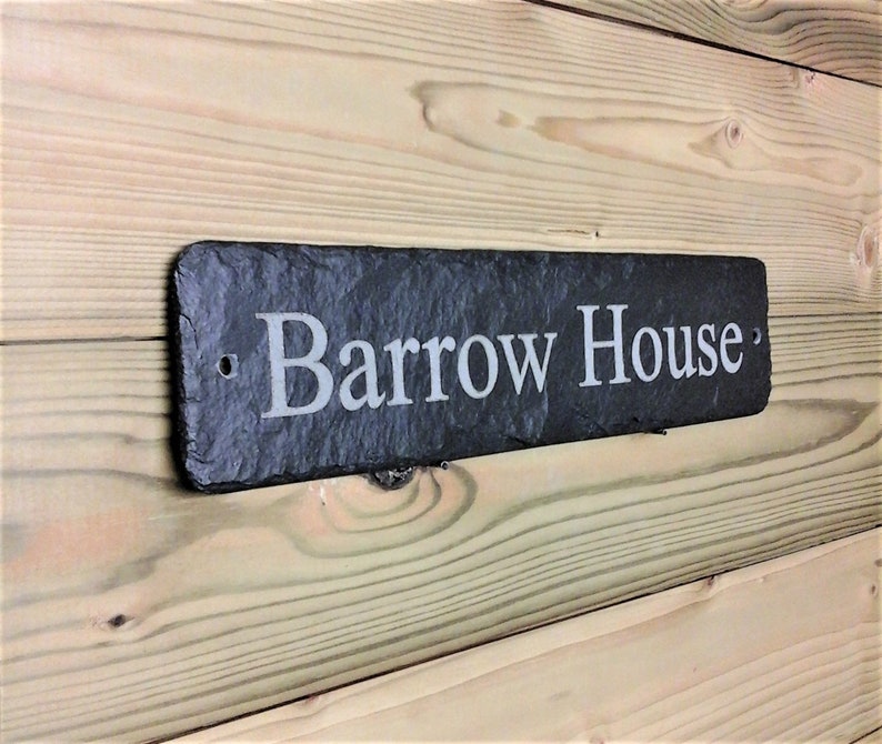 May include: A black slate house sign with the text "Barrow House" engraved in white.