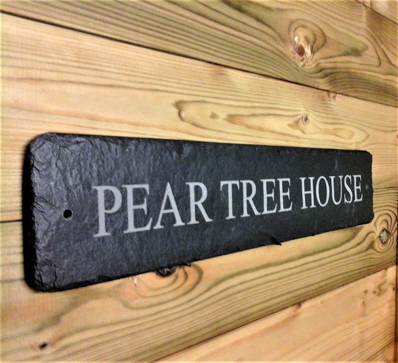 May include: Black slate house sign with the text "PEAR TREE HOUSE" in white lettering.