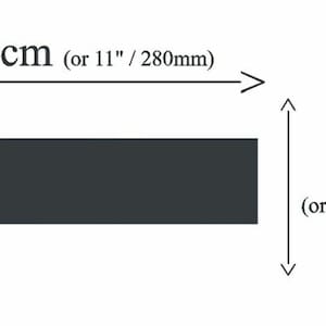 May include: A black rectangular object with dimensions of 28 inches by 2.7 inches. The object is labeled with the measurements in centimeters and millimeters.