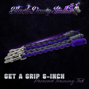 May include: Three 15 cm paracord training tabs featuring a braided design in black, grey, and purple. Each tab includes a silver-toned metal swivel snap hook at one end. The text Black Dawg Studio and GET A GRIP 6-INCH Paracord Training Tab is visible.