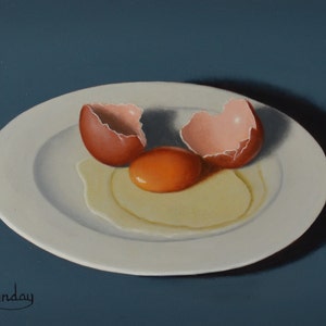 May include: A white plate with a broken brown egg and a yolk on a blue background. The egg yolk is orange and the egg white is runny.